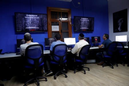People take part in a training session at Cybergym, a cyber-warfare training facility backed by the Israel Electric Corporation, at their training center in Hadera, Israel