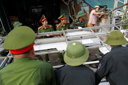 Vietnamese soldiers work at a damaged building after the Doksuri storm passed through Ha Tinh province, Vietnam September 16, 2017. REUTERS/Kham