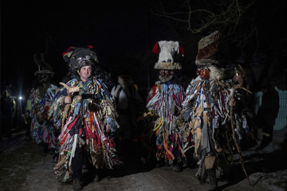 Participants, dressed in traditional costumes, celebrate the Malanka festival in the village of Krasnoilsk, Ukraine, Thursday, Jan. 13, 2022. (AP Photo/Ethan Swope)