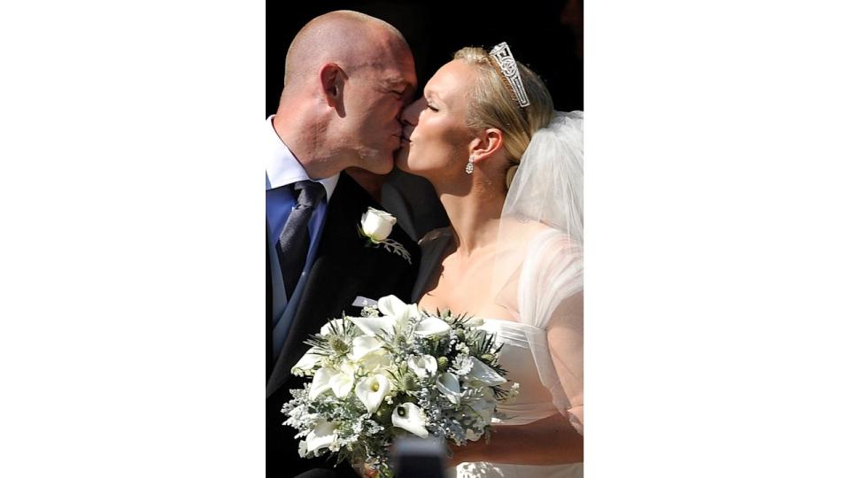 England rugby captain Mike Tindall and Zara Phillips kiss as they leave the church after their marriage at Canongate Kirk