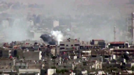 An image grab taken from a video uploaded on YouTube on August 13,allegedly shows smoke billowing from shelling on the Damascus district of al-Qadam as Syrian government forces bombarded rebel strongholds around the capital and rounded up residents in a massive raid in the heart of the the city, according to opposition activists