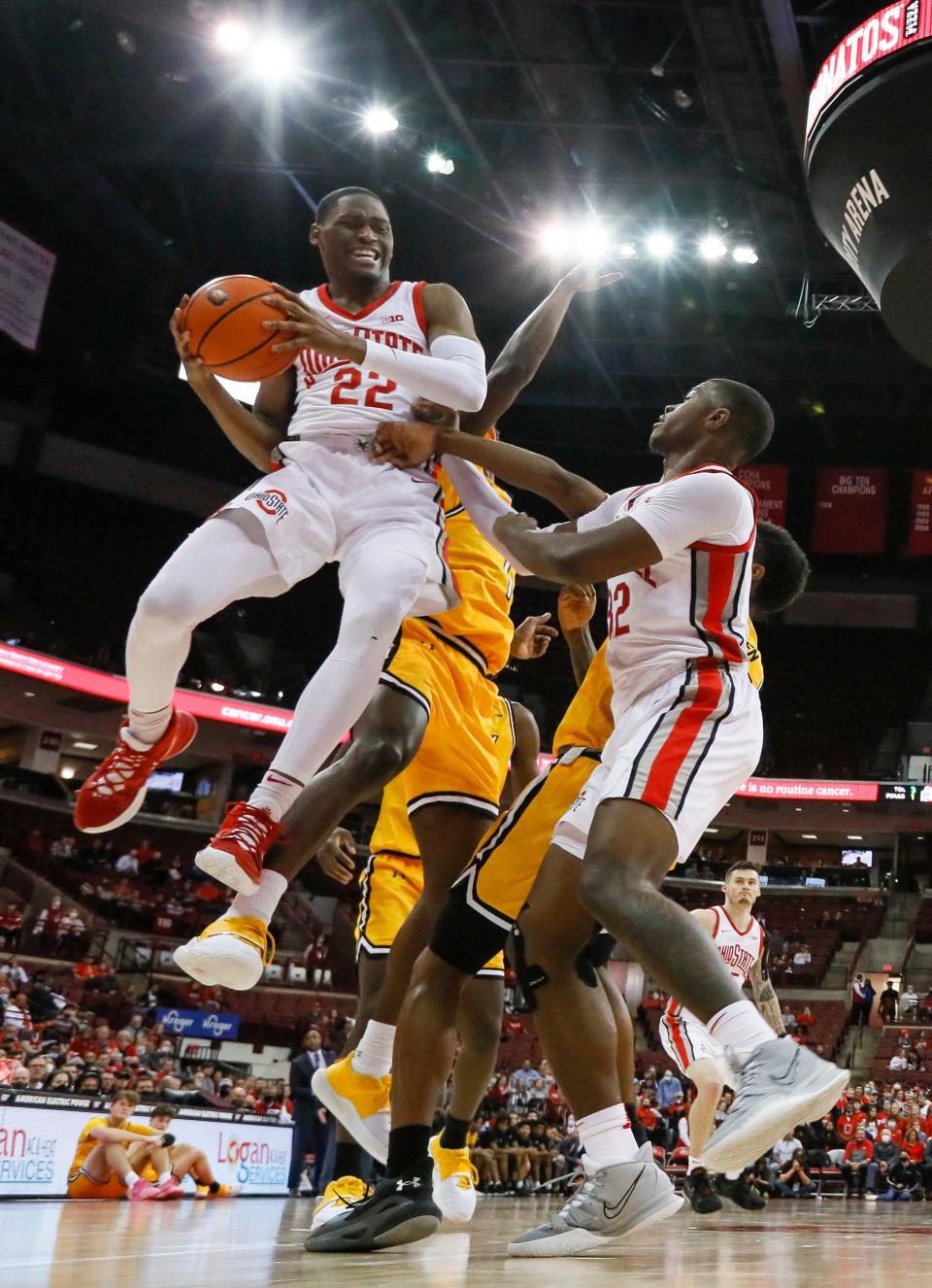 Ohio State Buckeyes guard Malaki Branham (22) goes up to the basket over Towson Tigers guard Terry Nolan Jr. (1) and forward E.J. Liddell (32) during the second half of the NCAA men's basketball game at Value City Arena in Columbus on Wednesday, Dec. 8, 2021.