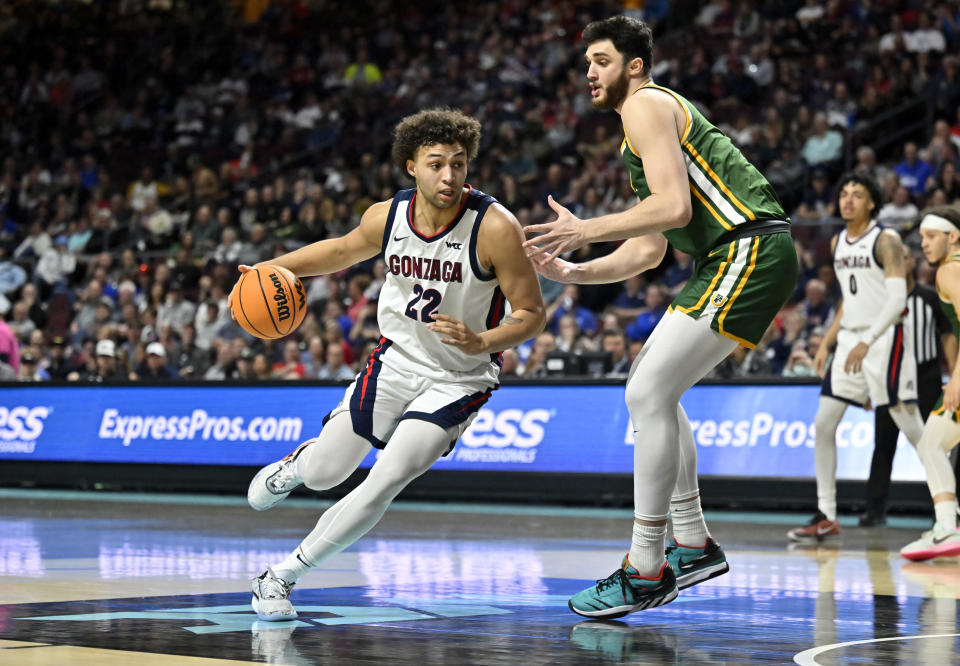 Gonzaga forward Anton Watson (22) drives the ball against San Francisco center Saba Gigiberia during the second half of an NCAA college basketball game in the semifinals of the West Coast Conference men's tournament Monday, March 6, 2023, in Las Vegas. (AP Photo/David Becker)