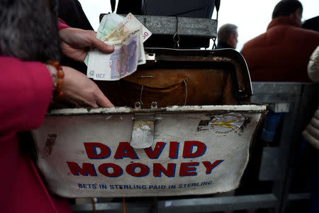 A bookmaker handles sterling and euro currency at the Punchestown Racecourse in Naas, Ireland, April 27, 2017. REUTERS/Clodagh Kilcoyne