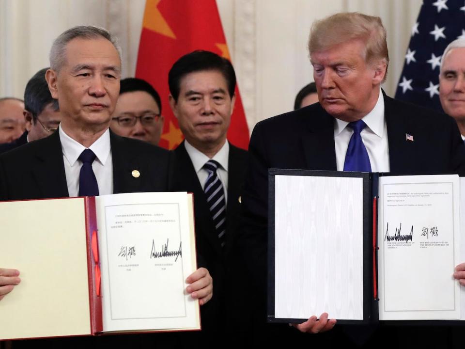 President Donald Trump holds the signed a trade agreement with Chinese Vice Premier Liu He, in the East Room of the White House, Wednesday, Jan. 15, 2020, in Washington