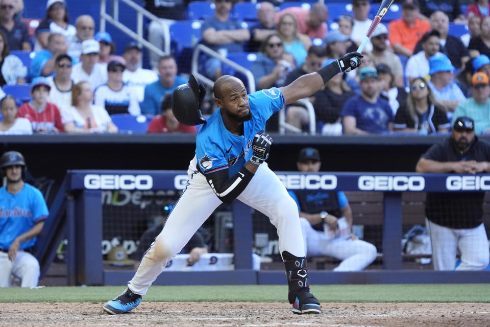 Miami Marlins' Bryan De La Cruz's helmet comes off as he strikes out during the eighth inning of a baseball game against the Atlanta Braves, Sunday, April 14, 2024, in Miami. (AP Photo/Wilfredo Lee)