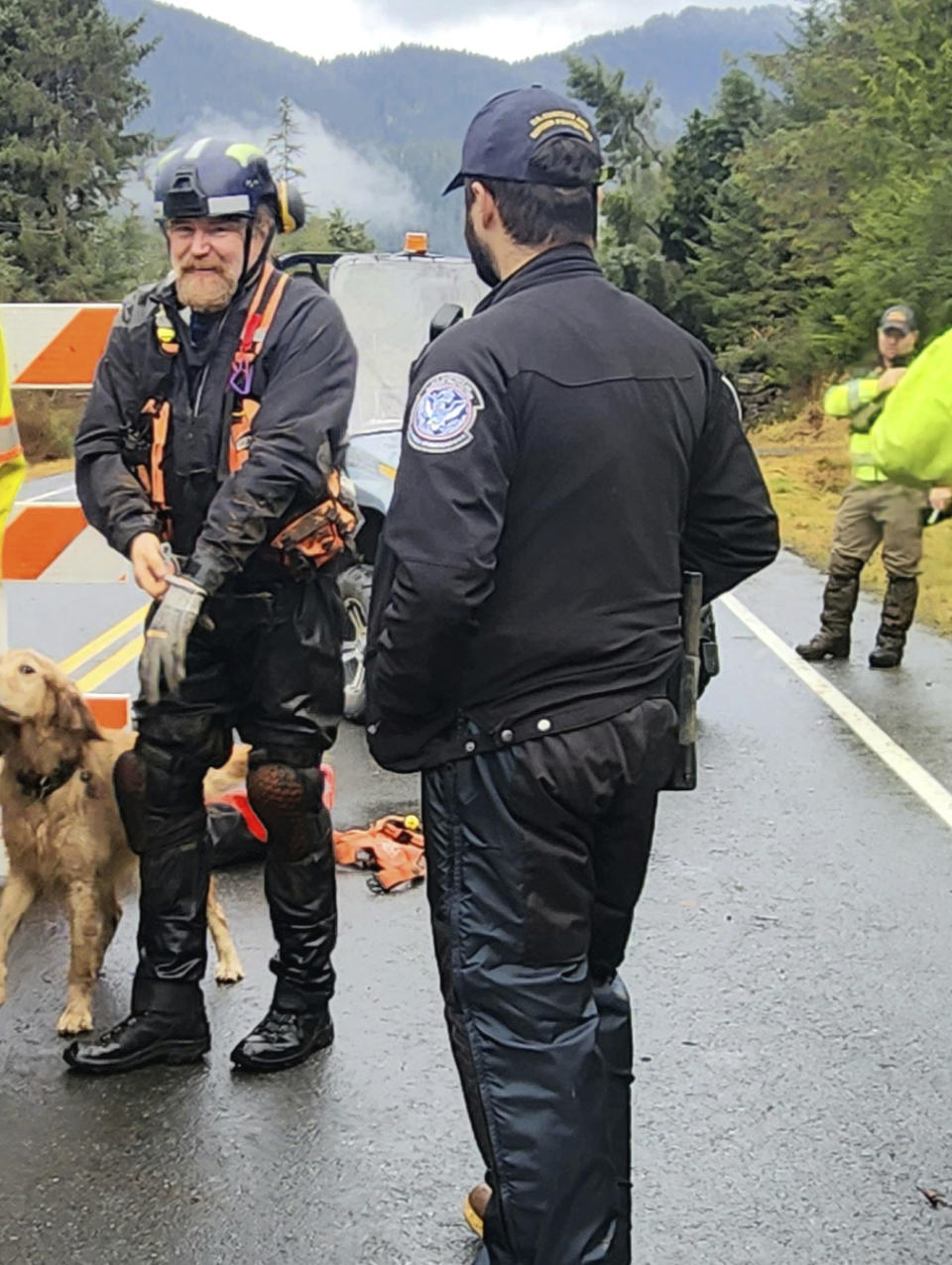 This photo provided by Division of Homeland Security and Emergency Management shows ground teams, including search and rescue dogs, actively work to search areas that state geologists have determined safe for entry, Wednesday, Nov. 22, 2023, in Wrangell, Alaska, following a massive landslide at mile 11 of the Zimovia Highway. Three people have died and searchers looked Wednesday for three others who remain missing after a landslide ripped through a remote Alaska fishing community on Monday, Nov. 20, 2023. (Willis Walunga/Division of Homeland Security and Emergency Management via AP)