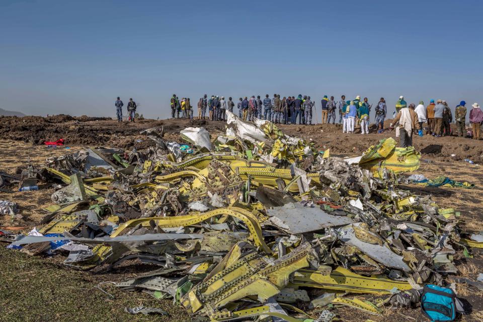 FILE - In this March 11, 2019, file photo, wreckage is piled at the crash scene of Ethiopian Airlines flight ET302 near Bishoftu, Ethiopia. The year since the crash of an Ethiopian Airlines Boeing 737 Max has been a journey through grief, anger and determination for the families of those who died, as well as having far-reaching consequences for the aeronautics industry as it brought about the grounding of all Boeing 737 Max 8 and 9 jets, which remain out of service. (AP Photo/Mulugeta Ayene, File)