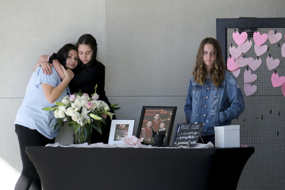 FILE - In this Nov. 23, 2019, file photo students stop at a table where mourners can write messages on pink hearts for the celebration of life for 15-year-old Gracie Anne Muehlberger, in Valencia, Calif., one of two students killed with a ghost gun in the Nov. 14, 2019, shooting at Saugus High School. California's attorney general sued the Trump administration on Tuesday, Sept. 29, 2020, in an effort to crack down on so-called "ghost guns" that can be built from parts with little ability to track or regulate the owner. (Dean Musgrove/The Orange County Register/SCNG via AP, File)