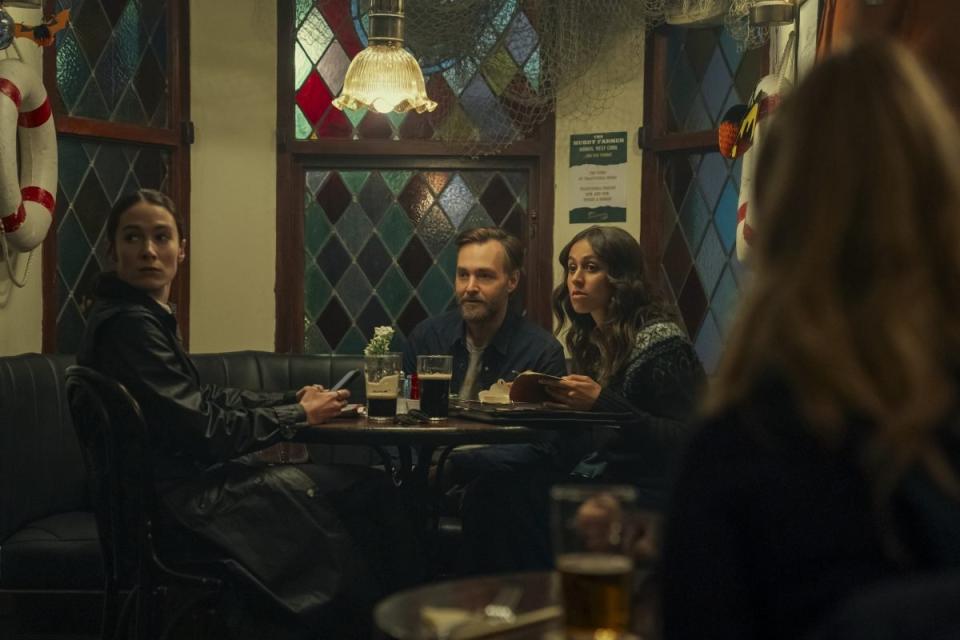 Three people sitting at a pub table on Bodkin