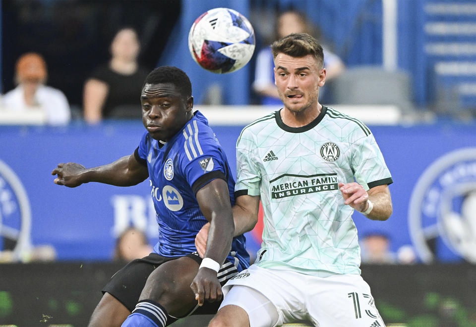 CF Montreal's Sunusi Ibrahim, left, defends against Atlanta United's Amar Sejdic during the first half of an MLS soccer match Saturday, July 8, 2023, in Montreal. (Graham Hughes/The Canadian Press via AP)