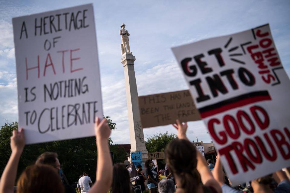 People gather during a protest at the Confederate monument in downtown Franklin, Tenn., Friday, July 31, 2020. Protesters called for the removal of the Confederate monument.