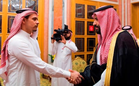 Saudi Crown Prince Mohammed bin Salman, right, shakes hands with Salah Khashoggi, a son, of Jamal Khashoggi, in Riyadh - Credit: AP