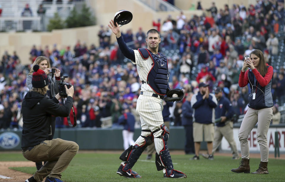 FILE - In this Sunday, Sept. 30, 2018, file photo, Minnesota Twins' Joe Mauer dons catcher's gear to catch for a pitch against a Chicago White Sox batter in the ninth inning of a baseball game, in Minneapolis. Mauer began his career as a catcher before switching to first base. The Minneapolis Star Tribune reports that Mauer has taken out an ad in its Sunday, Nov. 11, 2018, paper to announce his retirement. (AP Photo/Jim Mone, File)