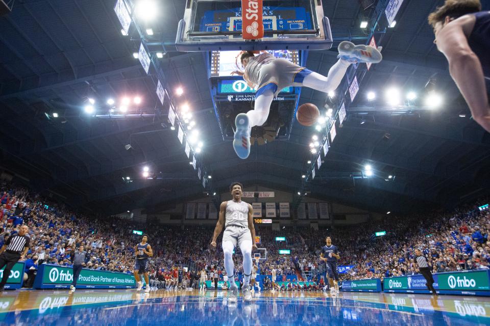 Kansas junior guard Christian Braun (2) dunks over Nevada during the first half of their game on Dec. 29, 2021, inside Lawrence's Allen Fieldhouse. This photo placed second in the annual Kansas Press Association journalism contest's Division VII sports photo category after being taken by Evert Nelson, chief photojournalist/creative director for The Capital-Journal.