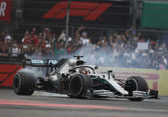 Mercedes driver Lewis Hamilton, of Britain, burns rubber as he celebrates his victory in the Formula One Mexico Grand Prix auto race at the Hermanos Rodriguez racetrack in Mexico City, Sunday, Oct. 27, 2019. (AP Photo/Eduardo Verdugo)