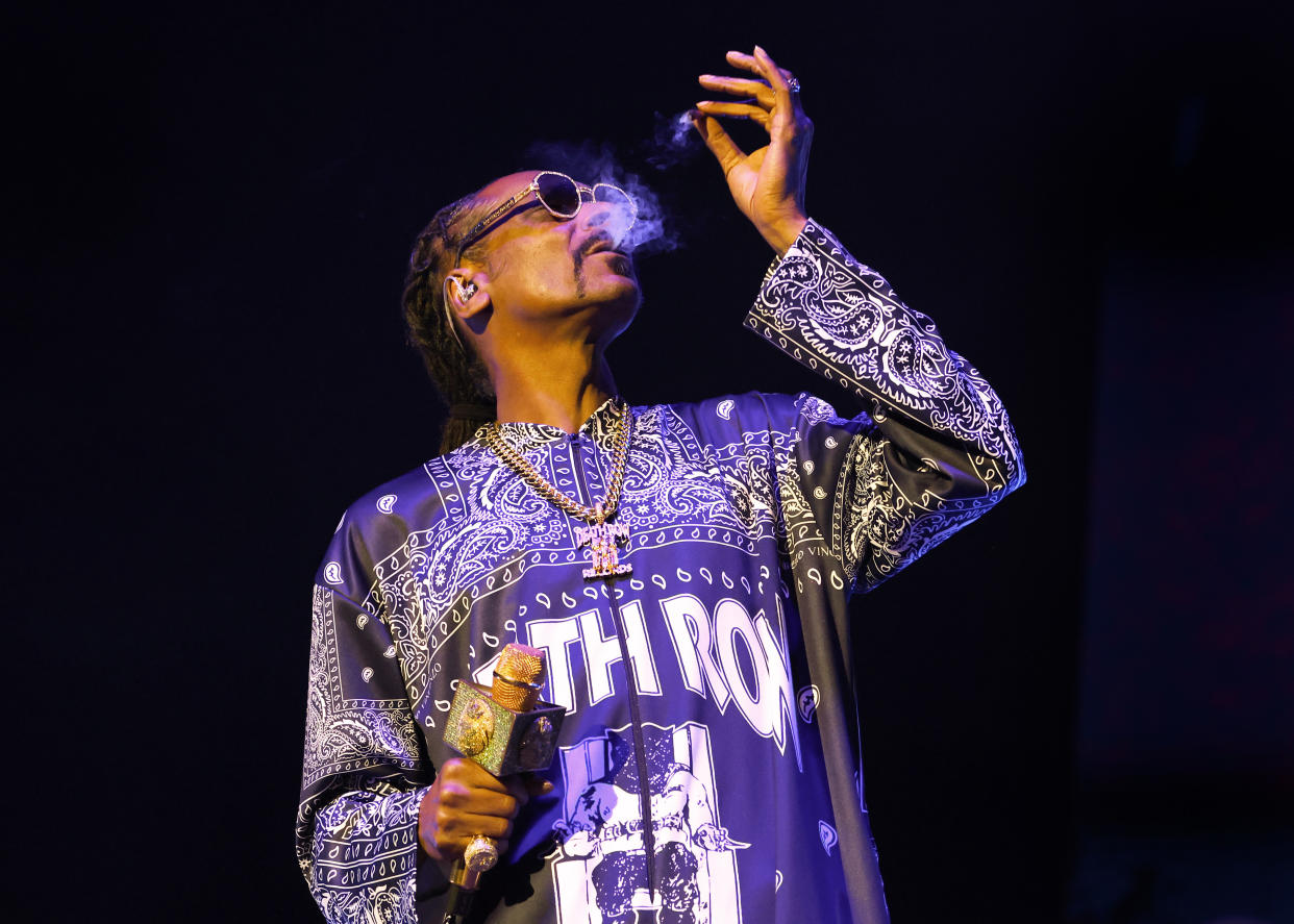 Snoop Dogg smokes a joint of marijuana as he performs at The O2 Arena on March 21, 2023 in London