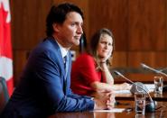 Canada's Deputy Prime Minister and Minister of Finance Chrystia Freeland, and Canada's Prime Minister Justin Trudeau listen to a question at a news conference in Ottawa