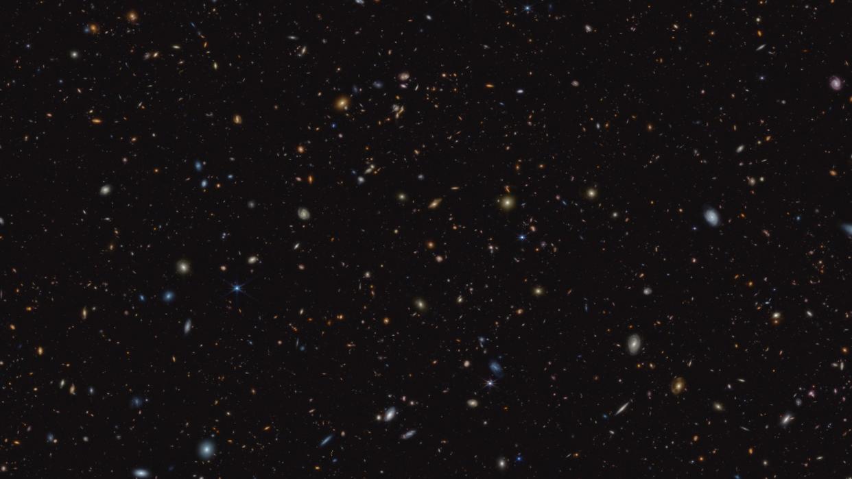  a wide view of deep space containing hundreds of galaxies 