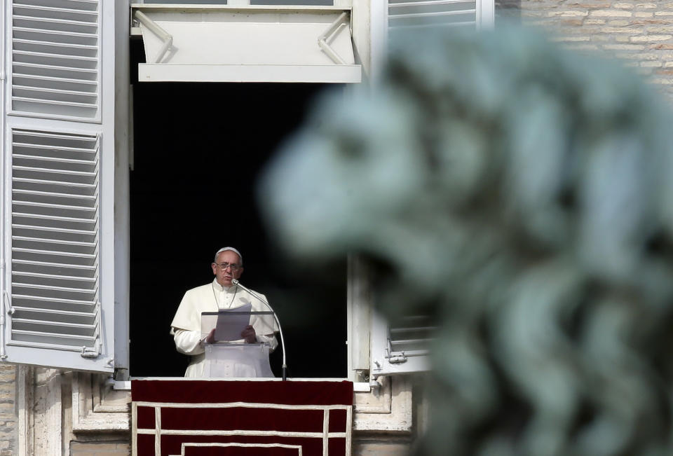 Pope Francis reads the list of 19 new Cardinals during the Angelus prayer in St. Peter's Square, at the Vatican, Sunday, Jan. 12, 2014. The pontiff has named his first batch of cardinals, choosing 19 men from Asia, Africa, North and South America and elsewhere, including Haiti and Burkina Faso, to reflect his attention to the poor. Francis made the announcement Sunday as he spoke from his studio window to a crowd in St. Peter's Square. (AP Photo/Gregorio Borgia)