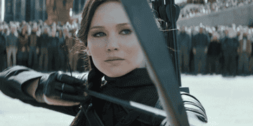 Katniss Everdeen from "The Hunger Games" movie drawing her bow