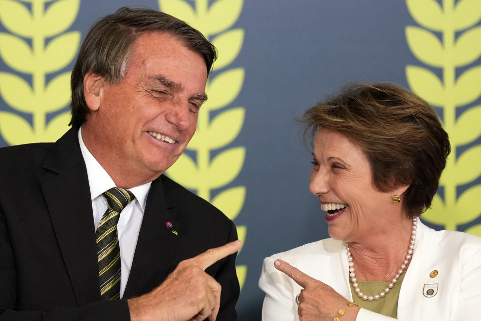 FILE - Brazil's President Jair Bolsonaro and former Agriculture Minister Tereza Cristina Dias, attend a ceremony launching a financial plan to promote rural production among small and medium farmers and ranchers, at the Planalto Presidential Palace, in Brasilia, Brazil, June 29, 2022. Cristina has become the face of the far-right president in Mato Grosso do Sul state — one of the agribusiness strongholds that is an important part of his effort to overcome leftist former President Luiz Inacio Lula da Silva. (AP Photo/Eraldo Peres, File)