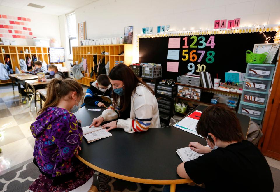 Third-grade teacher Mersadies Bowman helps students with reading Wednesday at Weaver Elementary.