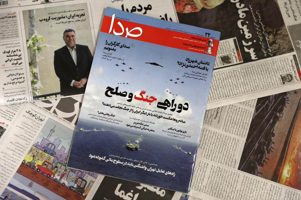 The front cover of the May 11, 2019 edition of the weekly reformist magazine, Seda, center, is photographed along with other periodicals in Tehran, Iran, May 12, 2019. Iranian authorities shut down Seda that had urged negotiations with the United States, local media reported Sunday. The main headline reads, “At the crossroads between war and peace.” (AP Photo/Vahid Salemi)