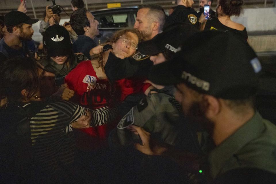 Israeli police disperse demonstrators blocking a highway during a protest calling on the government to reach a cease-fire deal with Hamas to bring home hostages in Tel Aviv, Israel, May 6, 2024. The protesters took to the streets after the government appeared to spurn a deal accepted by Hamas. Israel said it would continue negotiations. (AP Photo/Ariel Schalit)