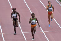 Crystal Emmanuel, of Canada, Marie-Josée Ta Lou, of The Ivory Coast, and Inna Eftimova, of Bulgaria, from left, compete in a women's 100 meter race heat during the World Athletics Championships in Doha, Qatar, Saturday, Sept. 28, 2019. (AP Photo/Martin Meissner)