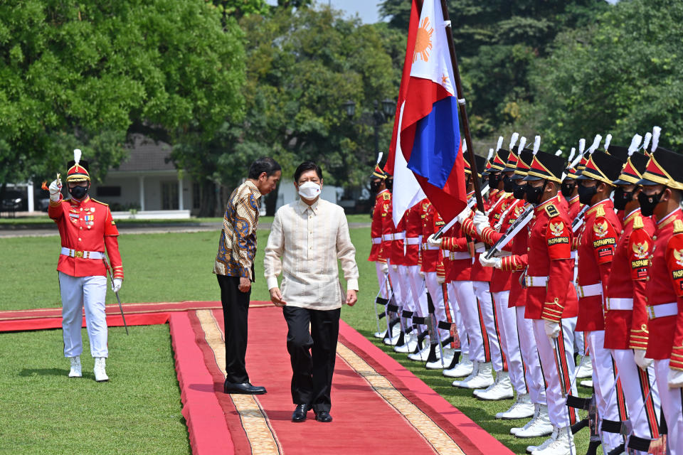 Philippine President Ferdinand Marcos Jr, center, escorted by Indonesian President Joko Widodo inspects an honor guard upon his arrival at the Presidential Palace in Bogor, West Java, Indonesia, Monday, Sept, 5, 2022. (Adek Berry/Pool Photo via AP)