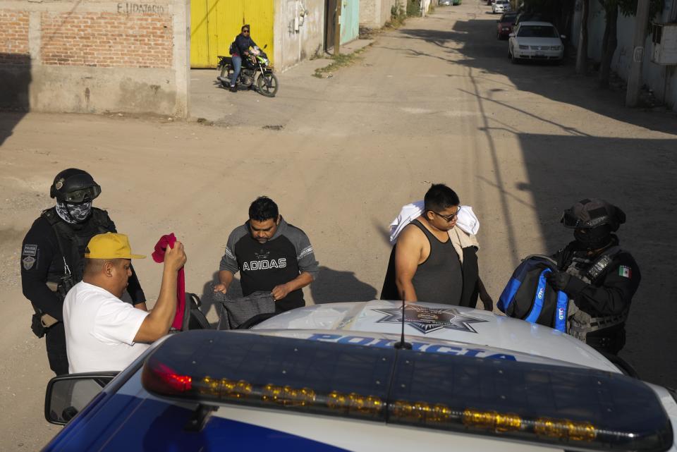 FILE - Municipal police officers conduct a pedestrian stop and search while on patrol in a neighborhood of Celaya, Mexico, Feb. 28, 2024. Most of Celaya’s municipal police force are former member of the federal police, earning the nickname “Fedepales,” a combination of the word “federal” and “municipal.” (AP Photo/Fernando Llano, File)