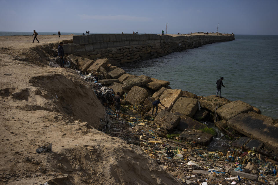 Palestinians walk by a pier that could be used to bring humanitarian aid to the Gaza Strip in Khan Younis on Wednesday, March 13, 2024. (AP Photo/Fatima Shbair)