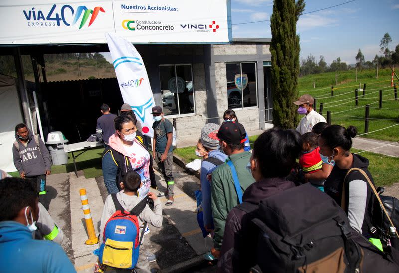 Venezuelan migrants line up to register at a migrant service point run by the International Rescue Committee (IRC) in Chusaca