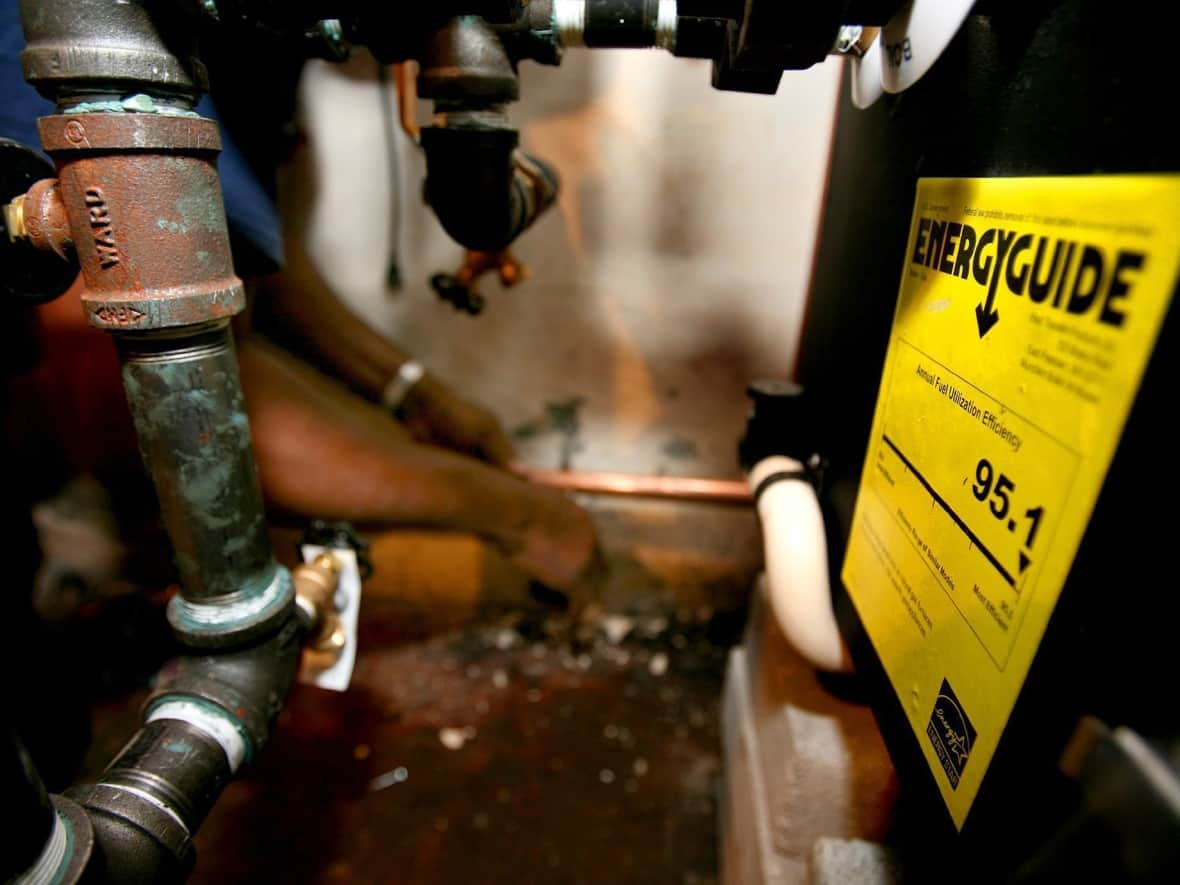 A high-efficiency natural gas furnace, hot water heater and air conditioning system is installed at a home in Ossining, N.Y. In Quebec, the replacement and installation of heating systems powered by fossil fuels will be banned by December 31, 2023. (Craig Ruttle/The Associated Press - image credit)