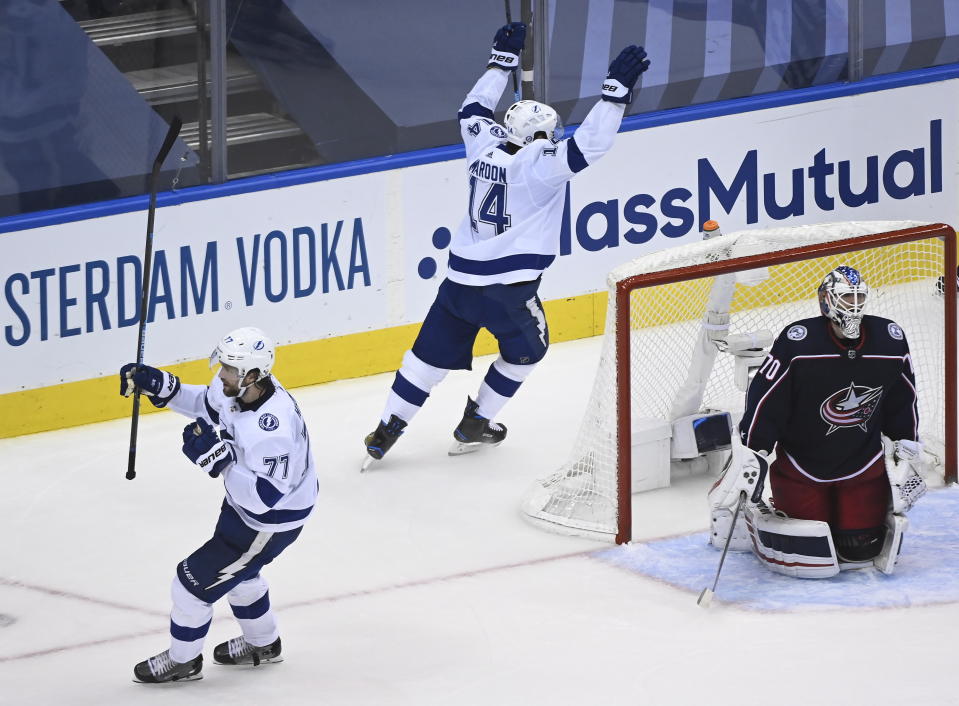 Tampa Bay Lightning defenseman Victor Hedman (77) celebrates his goal as Columbus Blue Jackets goaltender Joonas Korpisalo (70) looks on during the second period of an NHL Eastern Conference Stanley Cup hockey playoff game in Toronto, Saturday, Aug. 15, 2020. (Nathan Denette/The Canadian Press via AP)