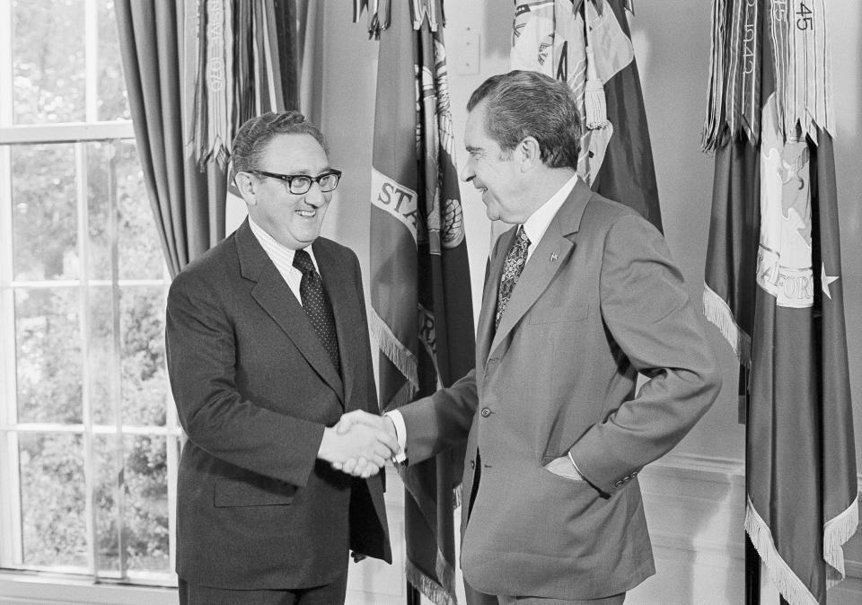 FILE - President Richard Nixon, right, offers his congratulations to Secretary of State Henry Kissinger, after the secretary won the 1973 Nobel Peace Prize, in the Oval Office of the White House in Washington, Oct. 16, 1973. Kissinger, the diplomat with the thick glasses and gravelly voice who dominated foreign policy as the United States extricated itself from Vietnam and broke down barriers with China, died Wednesday, Nov. 29, 2023. He was 100. (AP Photo/Jim Palmer, File)