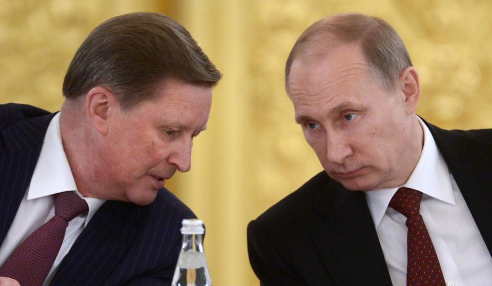 Kremlin's Chief of Staff Sergei Ivanov, left, speaks to Russian President Vladimir Putin during a Council of Physical Fitness and Sports in the Kremlin in Moscow, Russia, Monday, March 24, 2014. (AP Photo/RIA-Novosti, Alexei Nikolsky, Presidential Press Service)