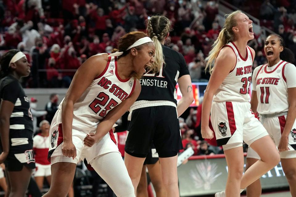 NC State forward Kayla Jones (25), center Elissa Cunane (33) and forward Jakia Brown-Turner (11) celebrate after Cunane's layup against Louisville. Cunane finished with 15 points and 12 rebounds, and Brown-Turner added 14 points.