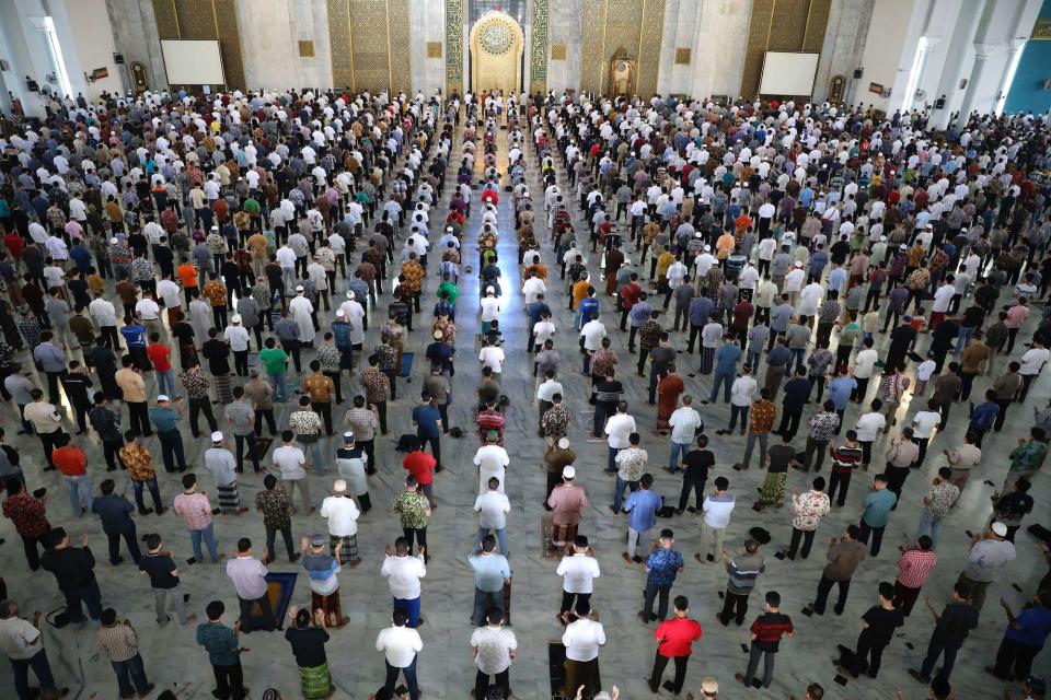 Muslim men perform Friday prayer at the distance of about one meter (3 ft) to each other as a social distancing effort to prevent the spread of new coronavirus outbreak at Al Akbar mosque in East Java, Indonesia, on March 20.