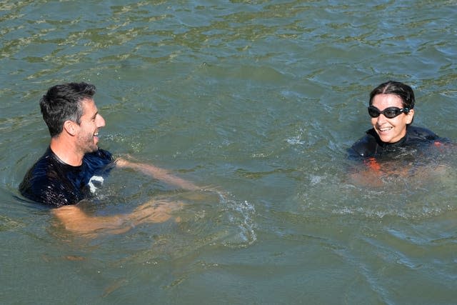 Paris Mayor Anne Hidalgo, right, and Tony Estanguet, president of Paris 2024, smiling and swimming in the Seine earlier this month 