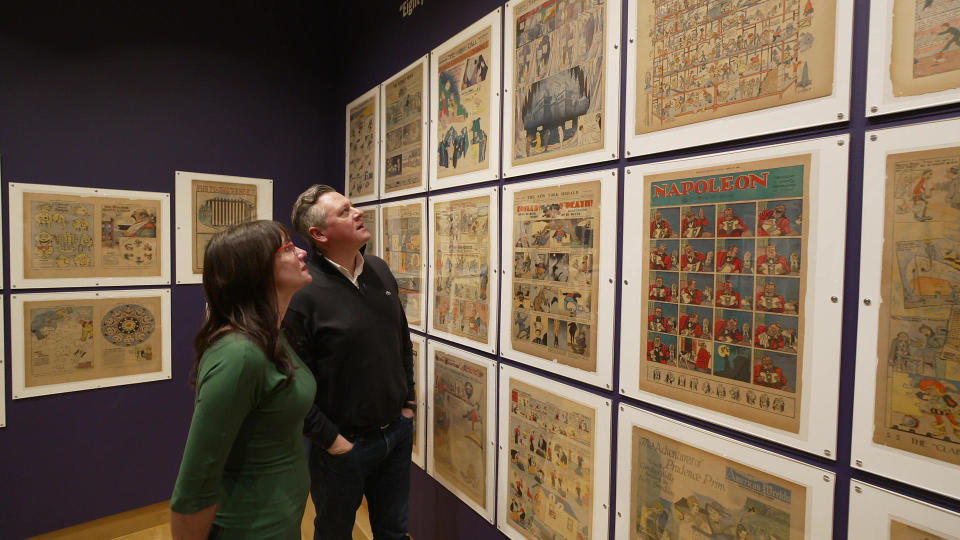 Curator Caitlin McGurk and correspondent Luke Burbank observe the exhibit 