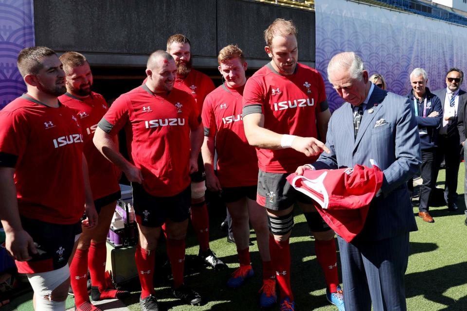 Charles is presented with a Wales shirt by Alun Wyn Jones (AP)