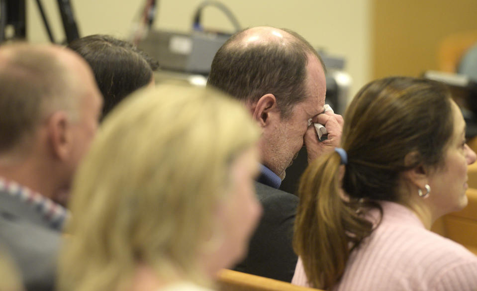 David Wheeler wipes away tears as attorney Chris Mattei shows a photograph of his family, including son Ben Wheeler, during closing statements in the Alex Jones Sandy Hook defamation damages trial in Superior Court in Waterbury, Conn., on Thursday, Oct. 6, 2022. (H John Voorhees III/Hearst Connecticut Media via AP, Pool)