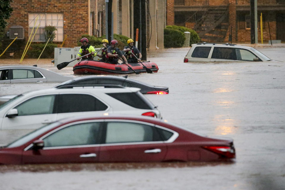 Residents of the Crescent at Lakeshore apartment complex are rescued by Homewood Fire and Rescue as severe weather produced torrential rainfall flooding several apartment buildings Tuesday, May 4, 2021 in Homewood, Ala. (AP Photo/Butch Dill)