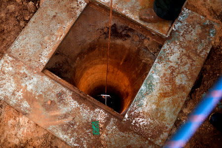 FILE PHOTO: An Israeli soldier lowers a camera down an Israeli-dug hole into a cross-border tunnel dug from Lebanon into Israel, as seen on the Israeli side of the border, near the town of Metula December 19, 2018. REUTERS/Ronen Zvulun/File Photo