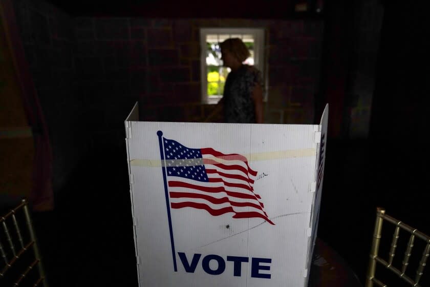 FILE - A person waits in line to vote in the Georgia's primary election on May 24, 2022, in Atlanta. More than 1 million voters across 43 states have switched to the Republican Party over the last year, according to voter registration data analyzed by The Associated Press. (AP Photo/Brynn Anderson, File)