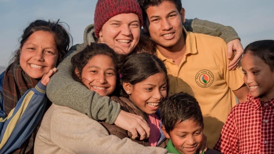 <span><span>Maggie Doyne with kids and teens of Kopila Valley</span><span>Blink Now</span></span>