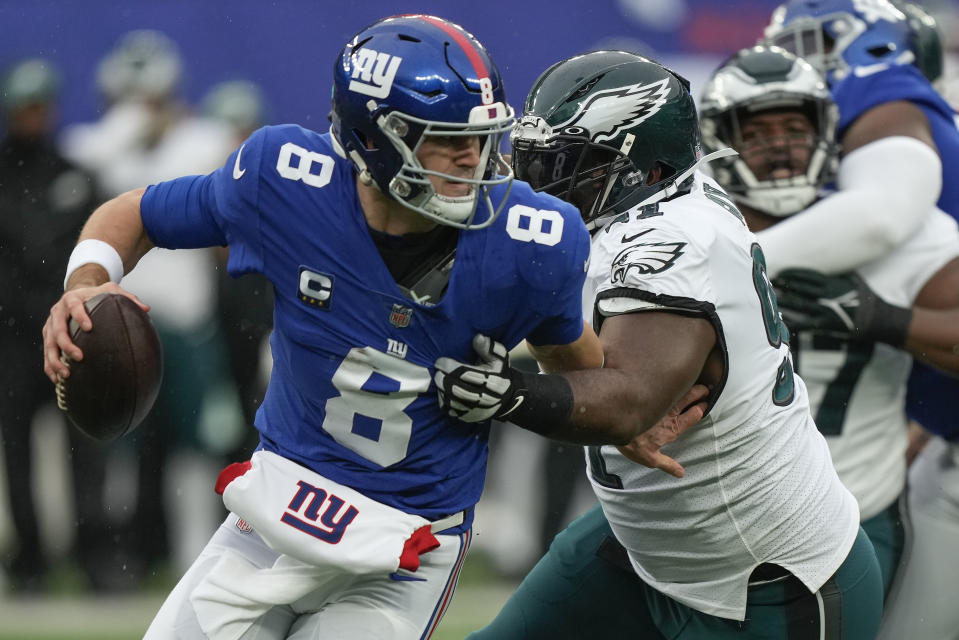 New York Giants quarterback Daniel Jones (8) is pressured by Philadelphia Eagles defensive tackle Fletcher Cox (91) during the second quarter of an NFL football game, Sunday, Dec. 11, 2022, in East Rutherford, N.J. (AP Photo/Bryan Woolston)