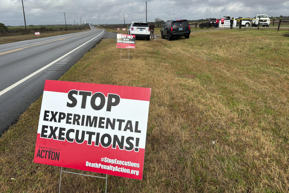 Anti-death penalty activists place signs along the road heading to Holman Correctional Facility in Atmore, Ala., ahead of the scheduled execution of Kenneth Eugene Smith on Thursday, Jan. 25, 2024. The state plans to put Smith to death with nitrogen gas, the first time the new method has been used in the United States. (AP Photo/Kim Chandler)
